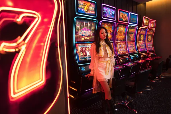 A confident dealer surrounded by casino chips inviting players to access their JLMMM account, reflecting quick and easy login options.